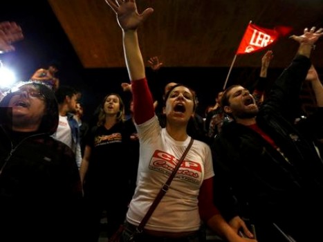 Protesters shout slogans in front of closed Ana Rosa subway station
