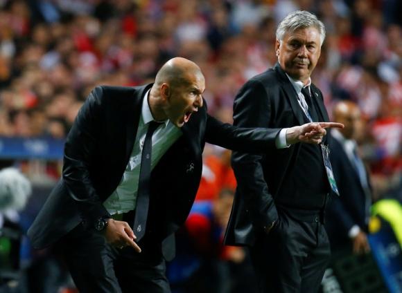 Real Madrid's coach Ancelotti watches his assistant Zidane shout at their players during their Champions League final soccer match against Atletico Madrid at Luz stadium in Lisbon