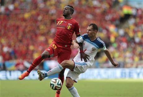 Russia's Sergei Ignashevich, right, challenges Belgium's Divock Origi
