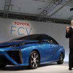 Toyota Motor Corp's Executive Vice President Mitsuhisa Kato speaks in front of the company's prototype fuel cell vehicle sedan car during a news conference at the company's showroom in Tokyo