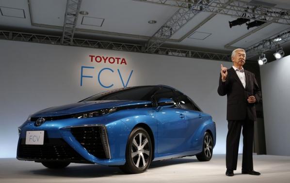 Toyota Motor Corp's Executive Vice President Mitsuhisa Kato speaks in front of the company's prototype fuel cell vehicle sedan car during a news conference at the company's showroom in Tokyo