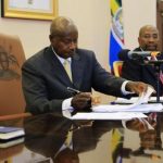 Uganda's President Yoweri Museveni signs an anti-homosexual bill into law at the state house in Entebbe