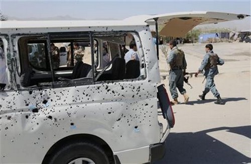 Afghan security personnel walk