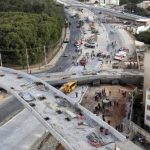 Rescue workers try to reach vehicles trapped underneath a bridge that collapsed while under construction in Belo Horizonte