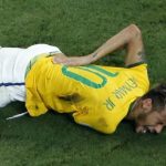 Brazil's Neymar grimaces in pain after a challenge in Fortaleza