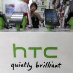 Customers look at HTC smartphones in a mobile phone shop in Taipei