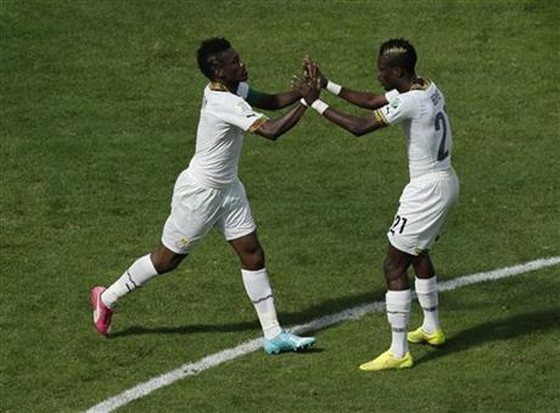 Ghana's Asamoah Gyan, left, celebrates with Ghana's John Boye, right