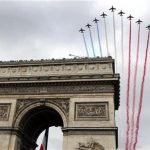 Jets for the Patrouille de France fly over the Arc de Triomphe