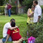 Neighbors embrace each other following a shooting Wednesday