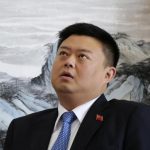 Chinese telecom tycoon Wang speaks during an interview with Reuters in Xinwei Telecom's headquarters in Beijing
