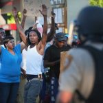 A crowd protests the killing of teenager Michael Brown