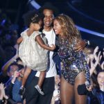 Beyonce smiles with Jay-Z and daughter Ivy Blue after accepting the Video Vanguard Award on stage during the 2014 MTV Video Music Awards in Inglewood