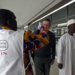 Health workers take passengers' temperatures infrared digital laser thermometers at the Felix Houphouet Boigny international airport in Abidjan