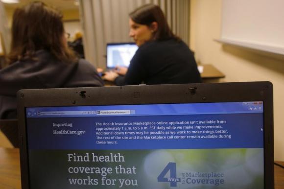 Liz Carlson, a self-employed student, gets help from navigator Eireann Aspell at a health care enrolment fair co-sponsored by Planned Parenthood of Northern New England and the State Employees Association at Great Bay Community College in Portsmouth