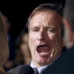File picture shows Academy Award winning actor Robin Williams joking with reporters as he arrives for the Los Angeles premiere of the film "One Hour Photo" in Beverly Hills, California