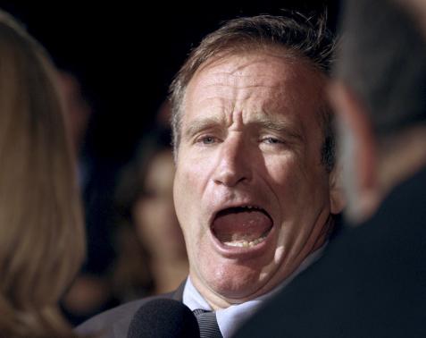 File picture shows Academy Award winning actor Robin Williams joking with reporters as he arrives for the Los Angeles premiere of the film "One Hour Photo" in Beverly Hills, California
