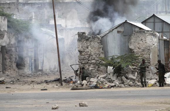Somali government soldiers hold their position against suspected militants during an attack at the Jilacow underground cell inside a national security compound in Mogadishu