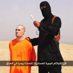 Still image from undated video of a masked Islamic State militant holding a knife speaking next to man purported to be James Foley at an unknown location