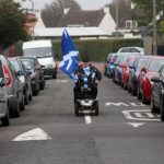 A man riding a mobility scooter arrives to take part in a "short walk to freedom" march in Edinburgh