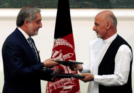 Afghan rival presidential candidates Abdullah Abdullah and Ashraf Ghani exchange signed agreements for the country's unity government in Kabul