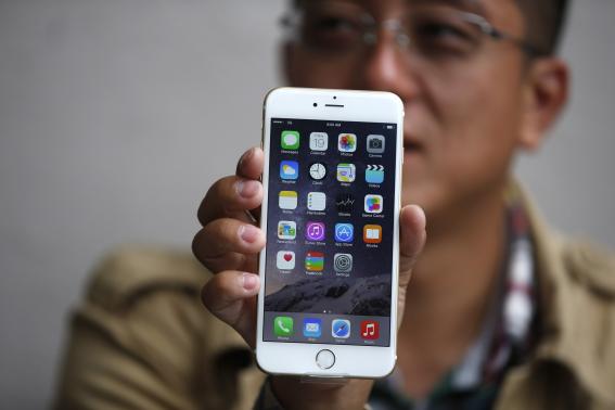 Tony Zhan, 32, holds up his new iPhone 6 Plus after it went on sale at the Apple store in Pasadena