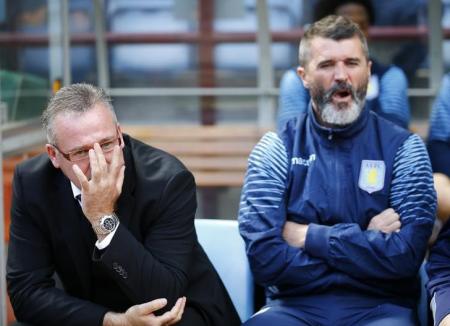 Aston Villa manager Lambert and his assistant Keane sits in the dugout before their English Premier League soccer match against Newcastle United at Villa Park in Birmingham