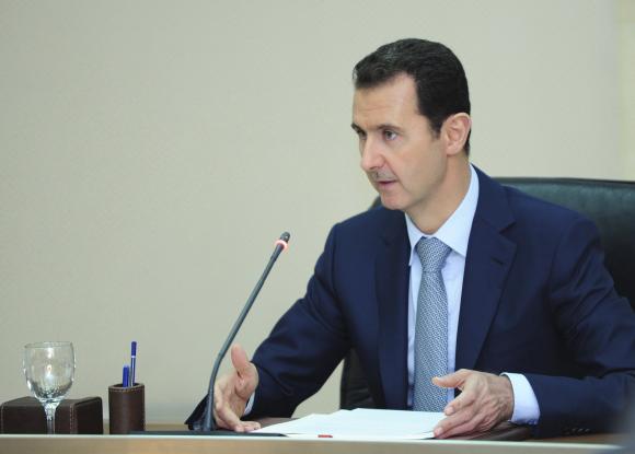 Syria's President Bashar al-Assad heads a meeting of his new cabinet in Damascus