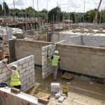 Construction workers build a new residential property development in north London