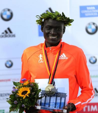 Kimetto of Kenya celebrates during the awards ceremony for the 41st Berlin marathon