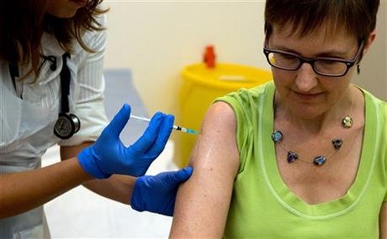 Dr Felicity Hartnell, who is a clinical research fellow at Oxford University, injects former nurse Ruth Atkins the first of 60 healthy volunteers in the U.K