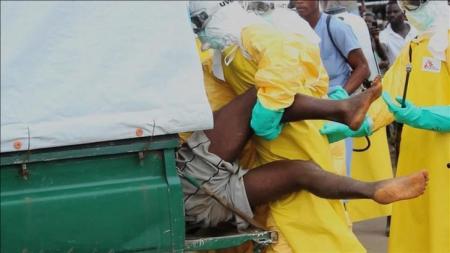 Video grab of health workers pushing an Ebola patient who escaped from quarantine from Monrovia's Elwa hospital, into an ambulance in the centre of Paynesville