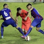Barcelona's Lionel Messi fights for the ball with Levante's Loukas Vyntra and Tono Garcia during their Spanish first division soccer match at the Ciudad de Valencia stadium in Valencia
