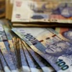 New South African bank notes featuring an image of former South African President Nelson Mandela are displayed at an office in Johannesburg