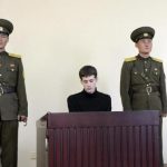 U.S. citizen Matthew Todd Miller sits in a witness box during his trial at the North Korean Supreme Court