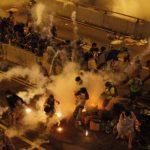 Riot police fire teargas to disperse protesters after thousands of demonstrators blocked the main street to the financial Central district outside the government headquarters in Hong Kong