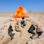 Shi'ite fighters, who have joined the Iraqi army to fight against militants of the Islamic State, formerly known as the Islamic State of Iraq and the Levant (ISIL), take part in field training in the desert in the province of Najaf