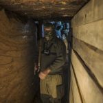 An American who calls himself "Hunter" walks inside a bunker near the town of Yasynuvata