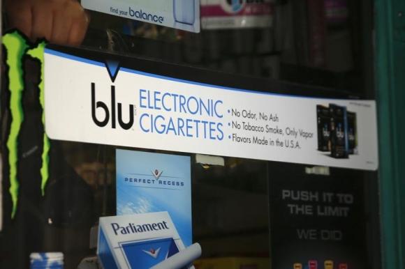 Advertisement for the e-cigarette brand blu is seen on window of a store in New York