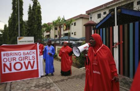 Campaigner from "#Bring Back Our Girls" shouts slogans during a rally calling for the release of the chibok school girls who were abducted by Boko Haram militants, in Abuja