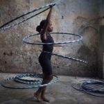 Girl performs with hoops during a training session at a circus school in Havana