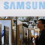 A journalists walks at the Samsung booth during a media preview day at the IFA consumer electronics fair in Berlin