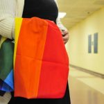 A supporter stands waits to congratulate gay couples as they receive their marriage licenses at the Oklahoma County courthouse in Oklahoma City