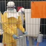 A volunteer for Medecins Sans Frontieres receives training on how to handle personal protective equipment during courses in Brussels