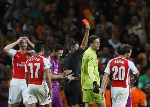 Arsenal goalkeeper Szczesny is shown a red card by match referee Rocchi during their Champions League soccer match against Galatasaray at the Emirates Stadium in London