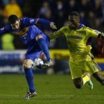 Shrewsbury Town's Grant challenges Chelsea's Drogba during their League Cup fourth round soccer match in Shrewsbury