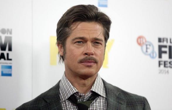 Actor Brad Pitt poses during a photocall for his film "Fury" in London