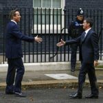 Britain's Prime Minister David Cameron greets his French counterpart Manuel Valls as he arrives at Number 10 Downing Street in London