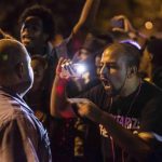 A demonstrator confronts a St. Louis Metropolitan Police officer in St. Louis