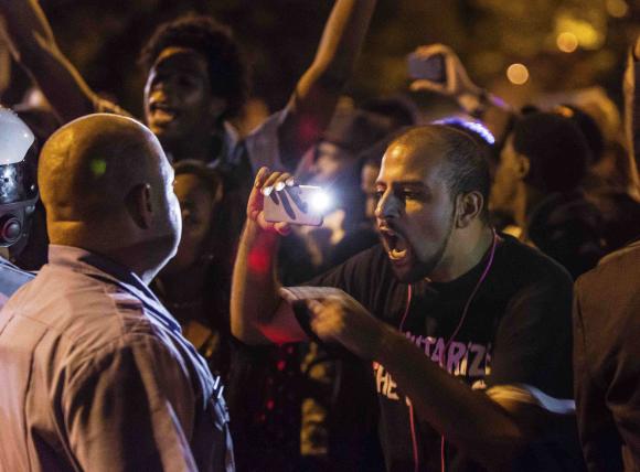 A demonstrator confronts a St. Louis Metropolitan Police officer in St. Louis