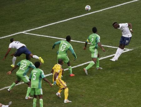 France's Pogba heads to score a goal against Nigeria during their 2014 World Cup round of 16 game in Brasilia